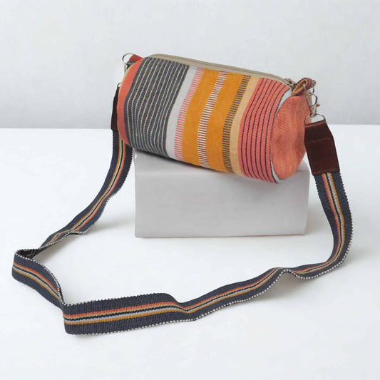 Bolso cilindro tonos calidos - Colección Raíces a rayas