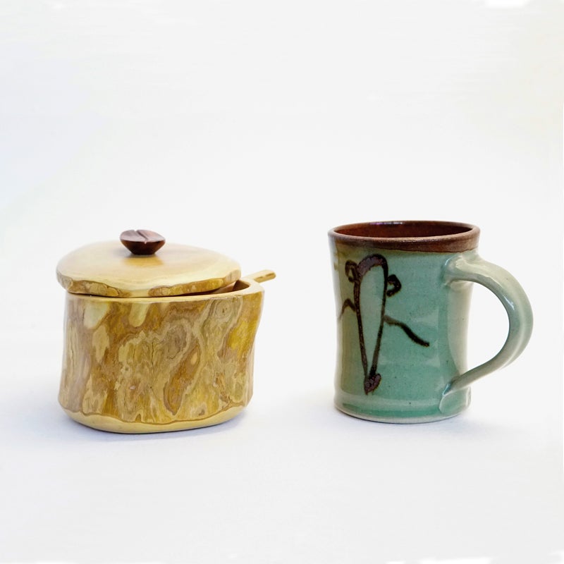 azucarera de madera junto a una taza de cerámica