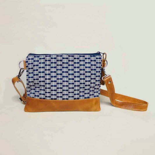 navy blue and white fabric and leather bag