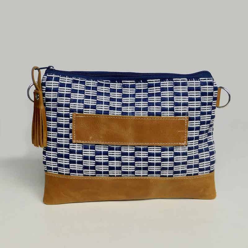 brown leather clutch bag with hand woven navy blue and white fabric